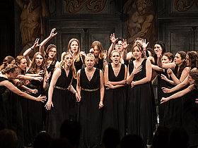 Sich bewegende und singende Chormitglieder auf der Bühne. Wertungssingen Deutscher Chorwettbewerb 2023. 